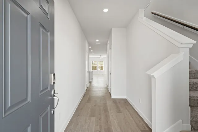 a view of a hallway with wooden floor