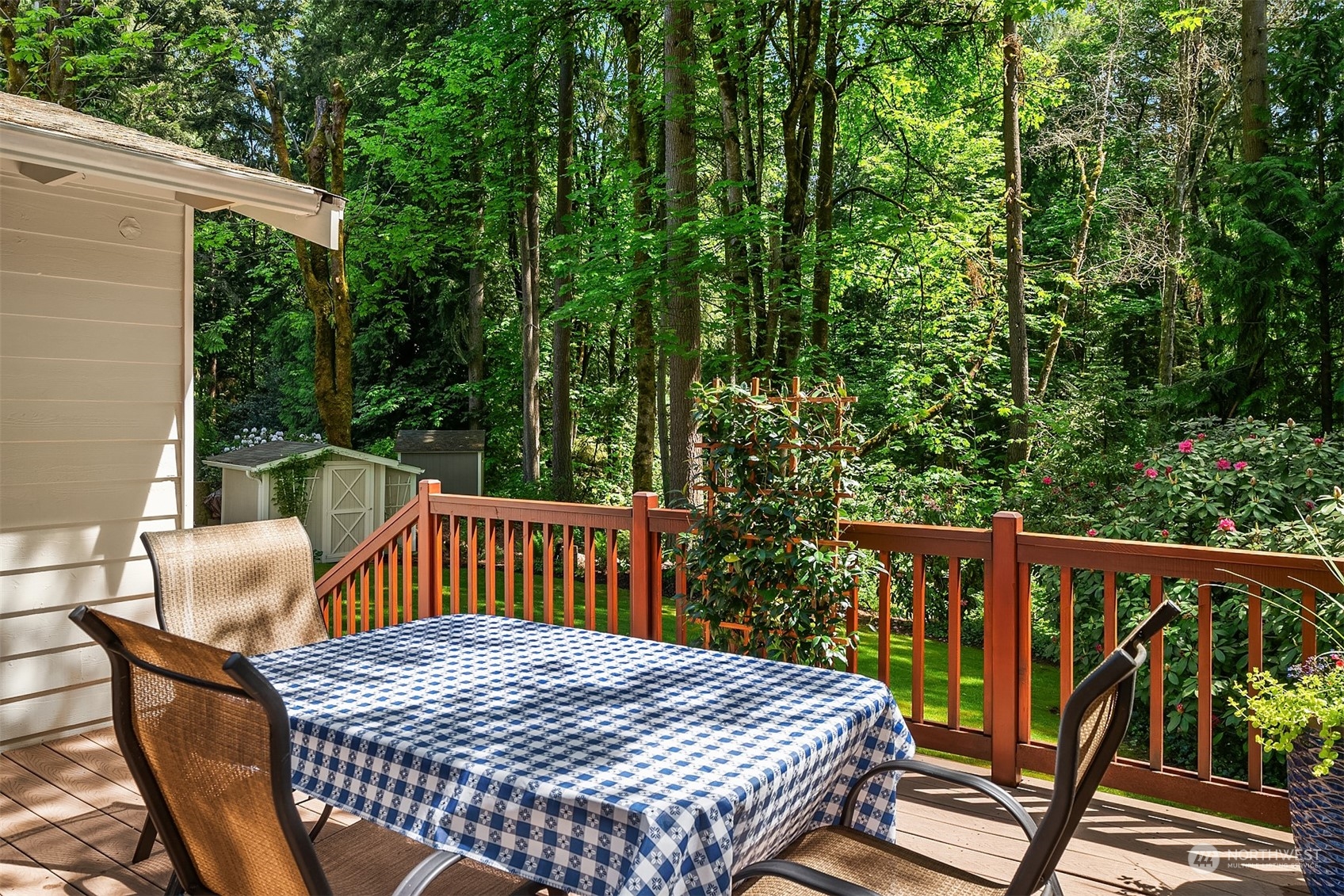 23017 38th Avenue Southeast Bothell, WA 98021 - Photo 32 of 38 a view of balcony with wooden floor outdoor seating and trees in the background