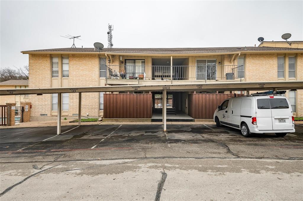 4664 Matilda Street, Unit F Dallas, TX 75206 - Photo 11 of 13 Rear view of property with brick siding, covered parking, and a balcony