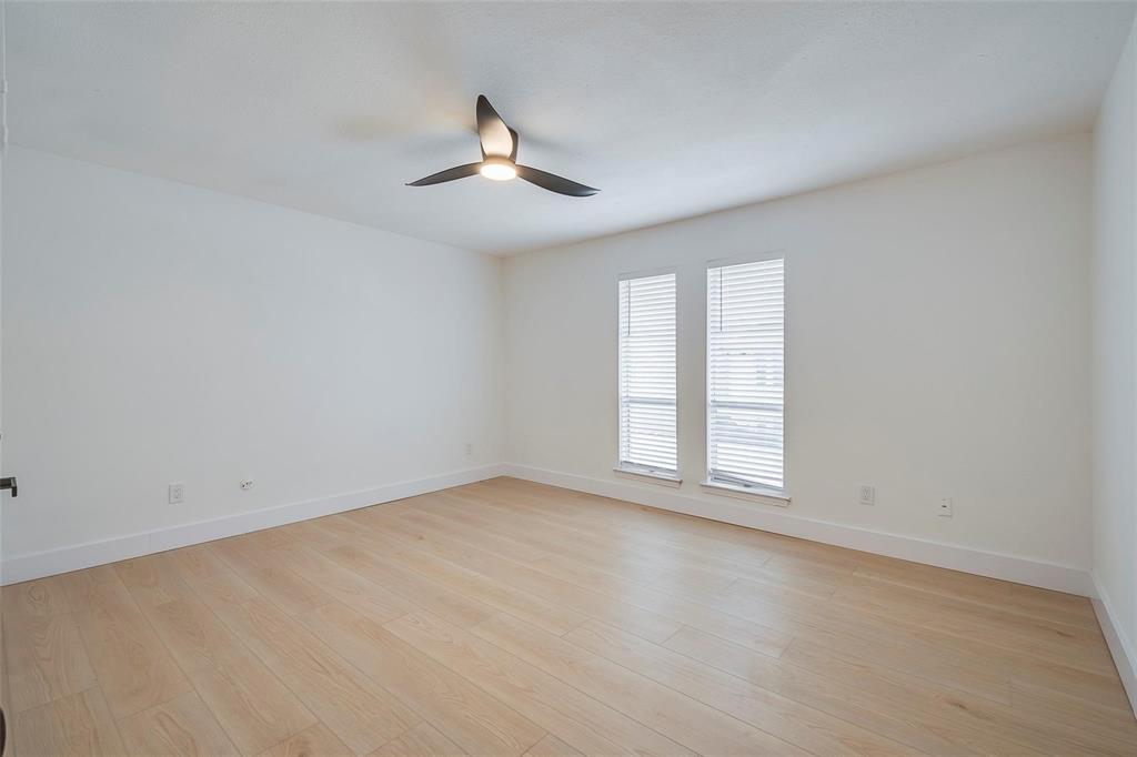 4664 Matilda Street, Unit F Dallas, TX 75206 - Photo 9 of 13 Empty room featuring light wood-style flooring and a ceiling fan