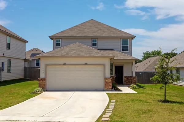 a front view of a house with a yard garage and outdoor seating