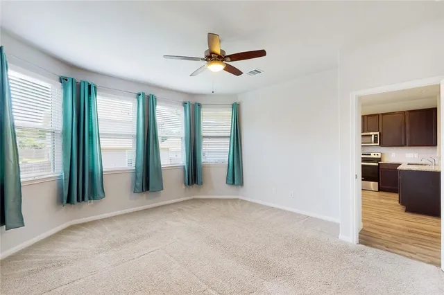 a view of livingroom with hardwood floor and ceiling fan