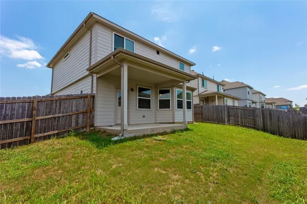 a view of a house with wooden fence