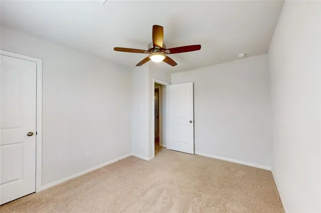 a view of a room with a ceiling fan
