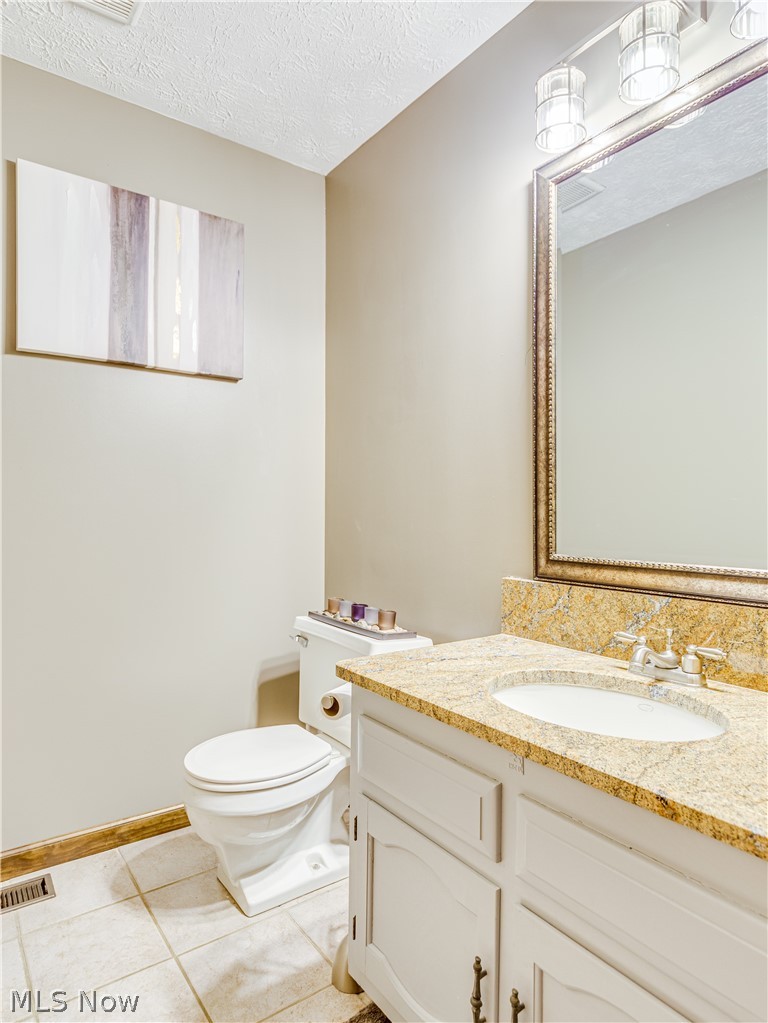 507 Everhard Road Southwest North Canton, OH 44709 - Photo 14 of 30 1/2 bath on the main floor off the foyer. This room sits right off the mudroom/garage
