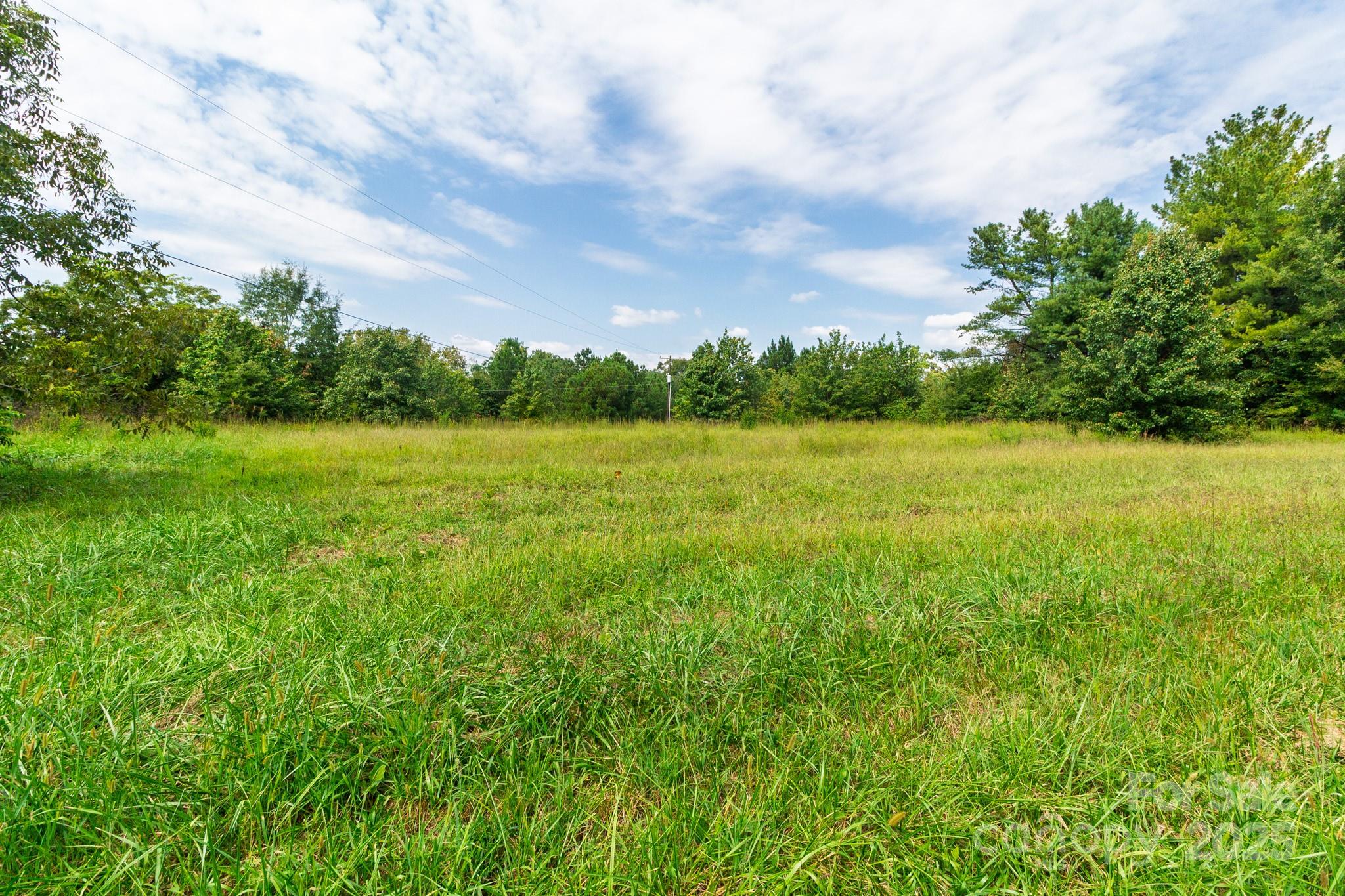 0 Putnam Lake Road Kings Mountain, NC 28086 - Photo 5 of 13 a view of field with trees in the background