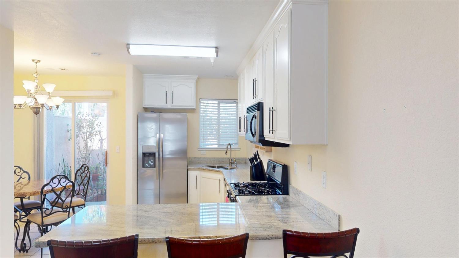 4057 Dale Road, Unit B Modesto, CA 95356 - Photo 7 of 39 a kitchen with stainless steel appliances refrigerator oven and cabinets