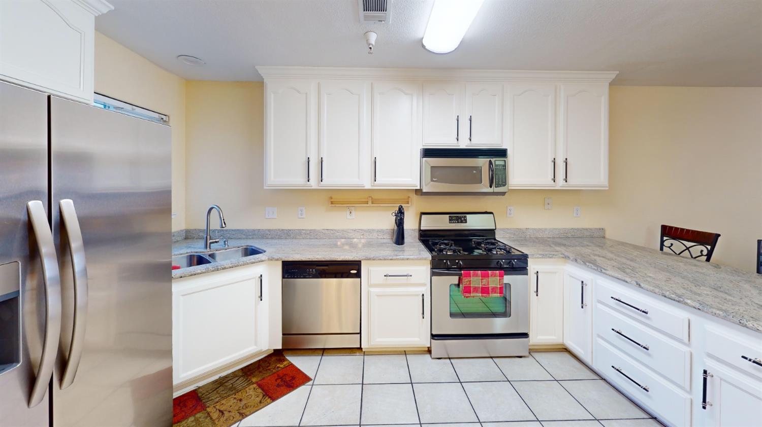 4057 Dale Road, Unit B Modesto, CA 95356 - Photo 10 of 39 a kitchen with stainless steel appliances granite countertop a stove a sink and a refrigerator