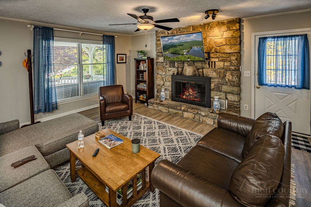 38 Rocky Meadows Road Newland, NC 28657 - Photo 7 of 50 a living room with furniture a flat screen tv and a fireplace