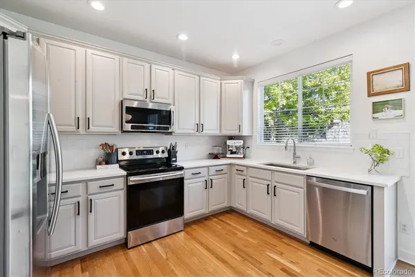 a kitchen with a sink cabinets and stainless steel appliances