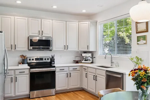a kitchen with a sink stove and microwave