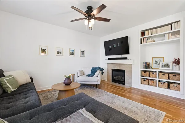 a living room with furniture a fireplace and a flat screen tv