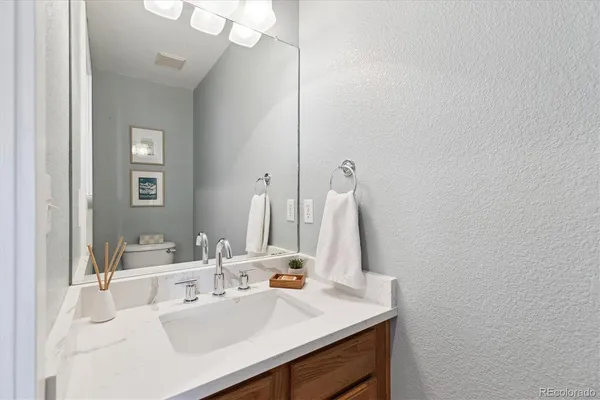a bathroom with a sink vanity and a mirror