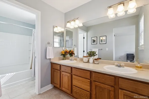 a bathroom with a tub sink and mirror