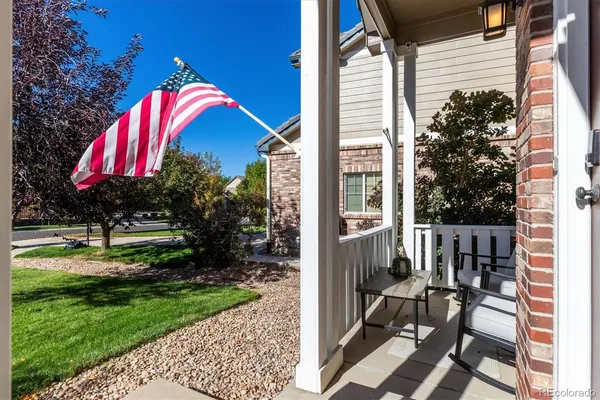 a view of a house with a yard and sitting area