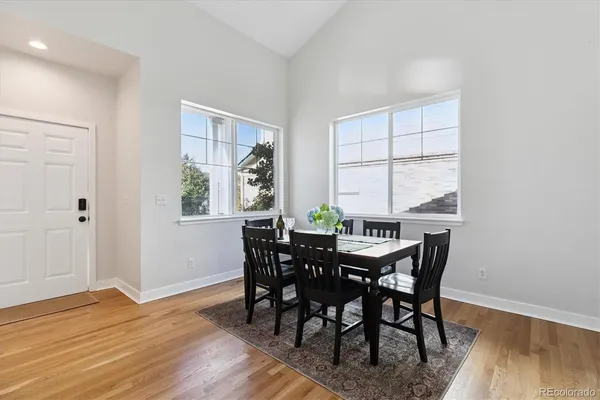 a view of a dining room with furniture and wooden floor