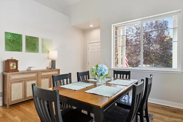 a view of a dining room with furniture window and wooden floor