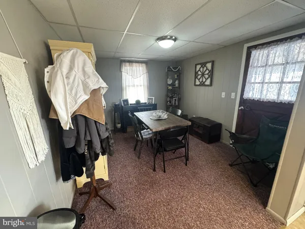 a living room with furniture a window and a flat screen tv