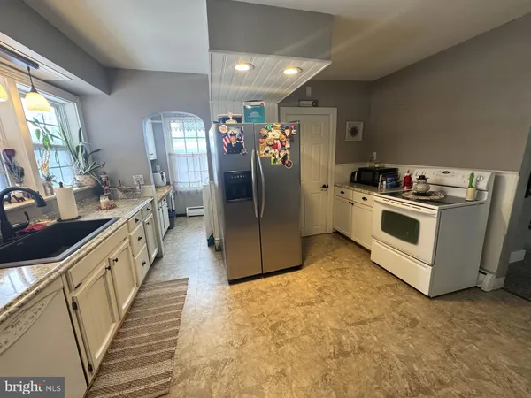 a kitchen with a sink and refrigerator