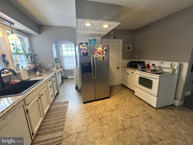 a kitchen with a sink and refrigerator