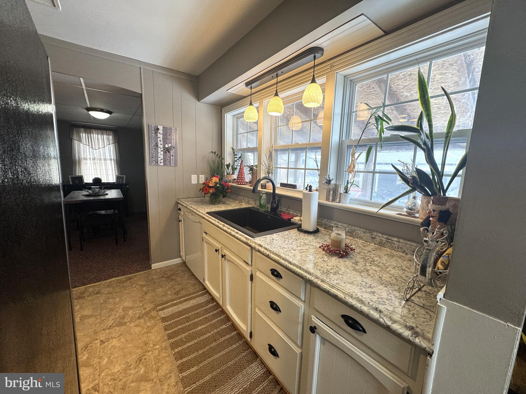 224 7th Avenue Burnham, PA 17009 - Photo 10 of 27 a large white kitchen with granite countertop a sink and a counter top space