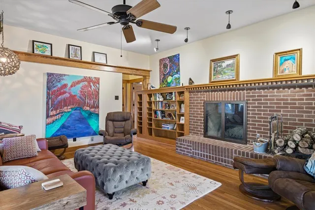 a living room with furniture a rug and a fireplace
