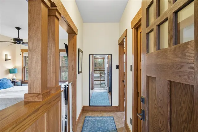 a view of a hallway with a dining area wooden floor and windows