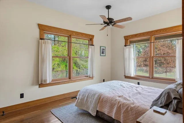 a bedroom with a bed and a large window