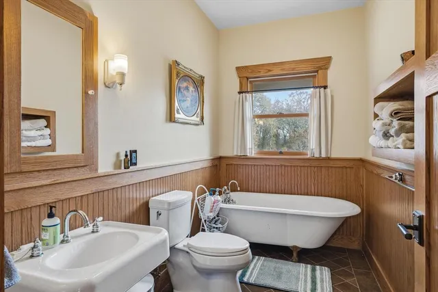 a bathroom with a toilet a sink and a window