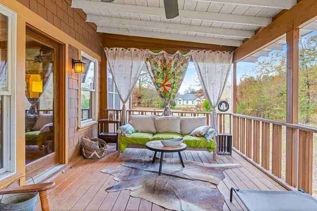 a balcony with chairs and a table