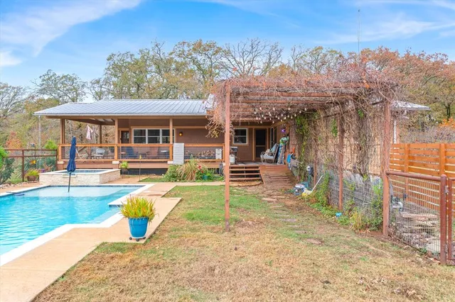 a view of a house with backyard porch and sitting area
