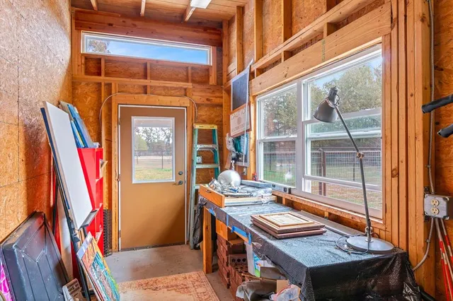 a view of a bedroom with furniture and a window