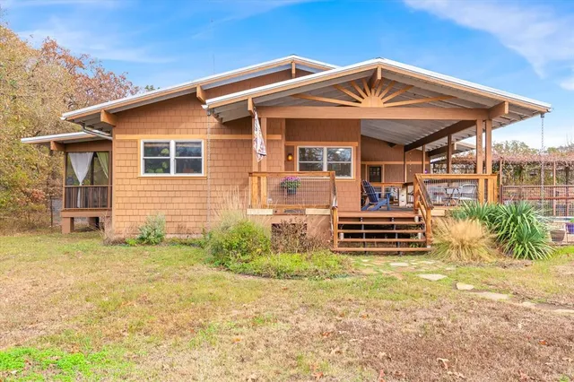 a backyard of a house with garden and barbeque oven