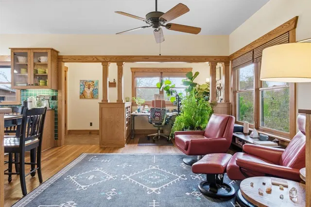 a living room with furniture a ceiling fan and a rug