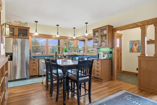 a view of a dining room with furniture window and wooden floor