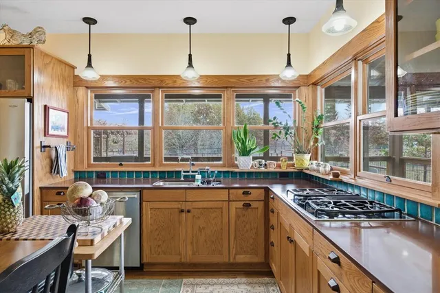 a kitchen with a sink stove and cabinets