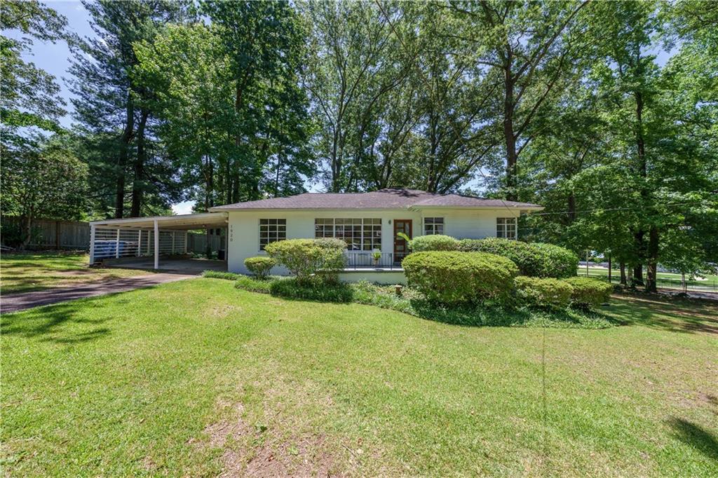 a view of a house with a backyard and a patio