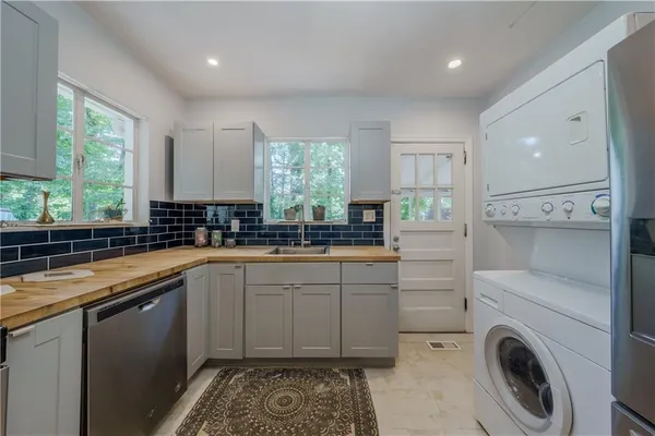 a kitchen with a sink cabinets and window