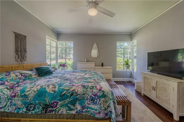 a bedroom with a bed and a flat screen television