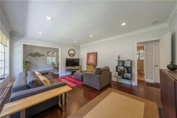 a living room with furniture and wooden floor