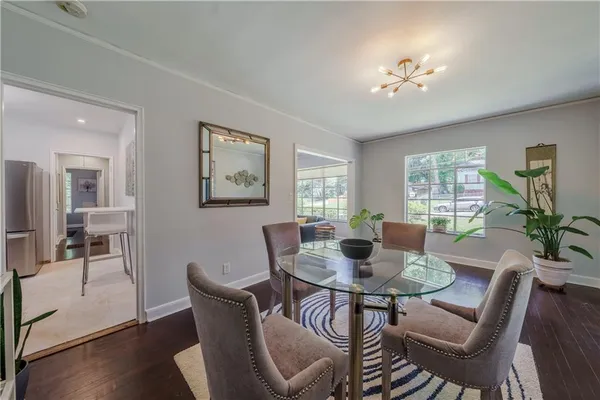a view of a dining room with furniture window and wooden floor