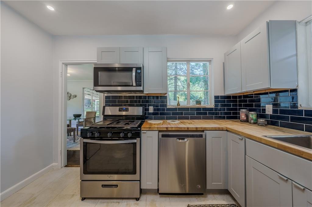 1920 West Forrest Avenue Atlanta, GA 30344 - Photo 10 of 28 a kitchen with stainless steel appliances a stove a sink and a microwave
