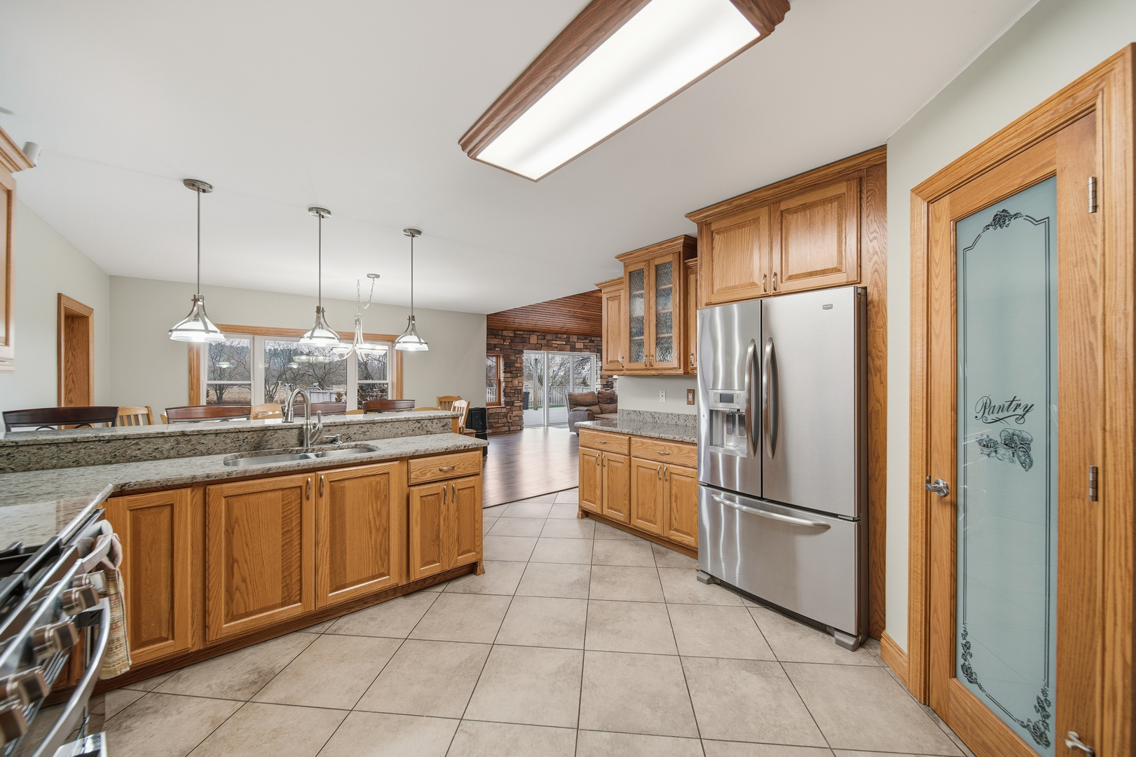 7231 South Lost Nation Road Dixon, IL 61021 - Photo 16 of 39 a kitchen with stainless steel appliances granite countertop a refrigerator a sink and white cabinets