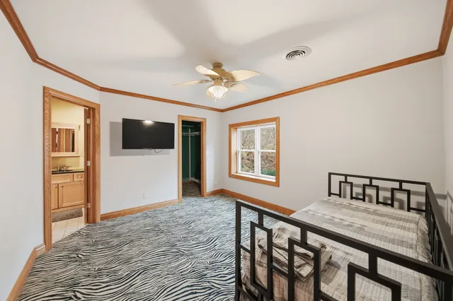 wooden floor in an empty room with a kitchen
