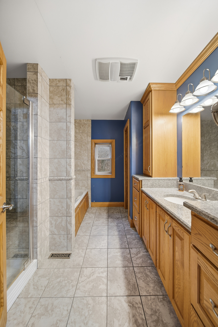7231 South Lost Nation Road Dixon, IL 61021 - Photo 31 of 39 a bathroom with a granite countertop sink and a mirror