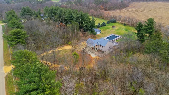 an aerial view of a house with a yard