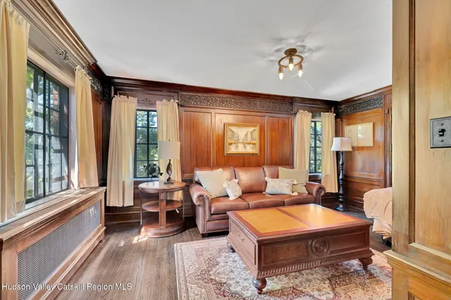 a living room with furniture and large windows