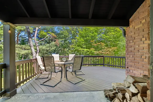 a view of a chairs and table in patio with wooden fence