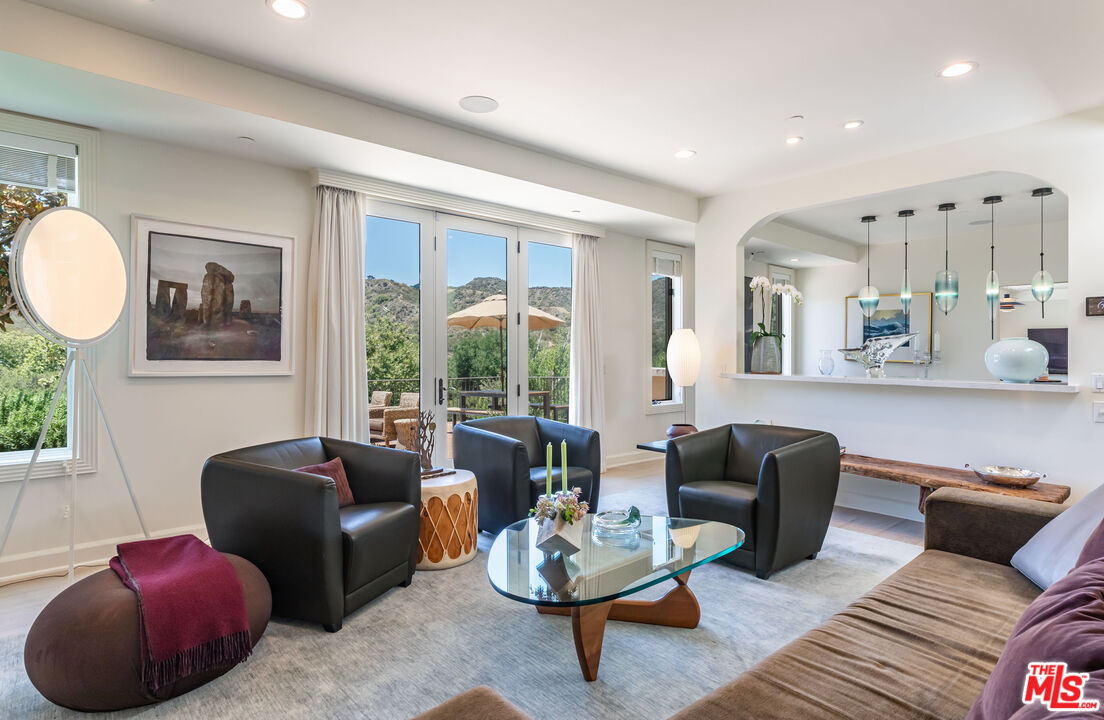 1045 Cold Canyon Road Calabasas, CA 91302 - Photo 14 of 51 a living room with furniture a rug and a large window