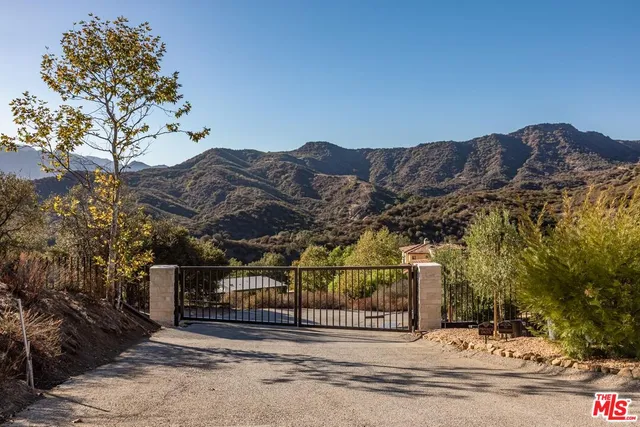 a view of a fence and a mountain view